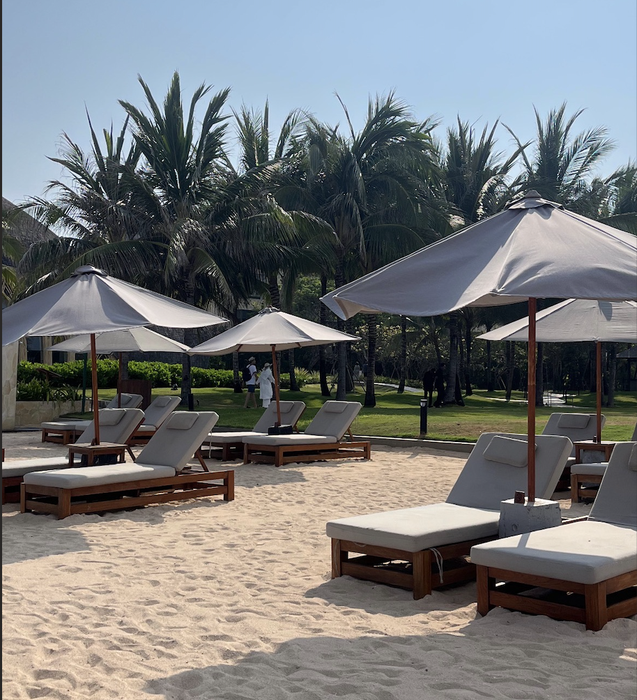Sun loungers and umbrellas on white sand
