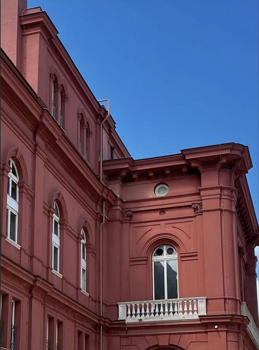 Terracotta facade against a blue sky